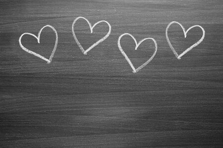chalk heart shapes on blackboardの写真素材