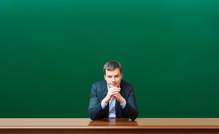 professor against chalkboard backgroundの写真素材