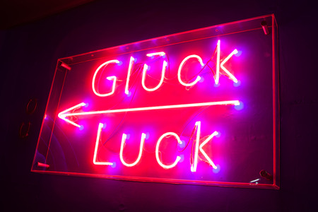 neon board with illuminated Luck textの写真素材