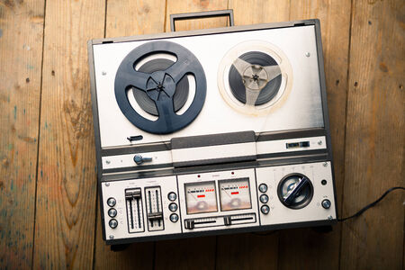 reel to reel tape player and recorder on wooden backgroundの写真素材