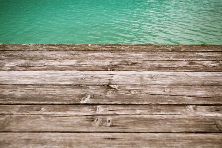 aged wooden pier background with waterの写真素材