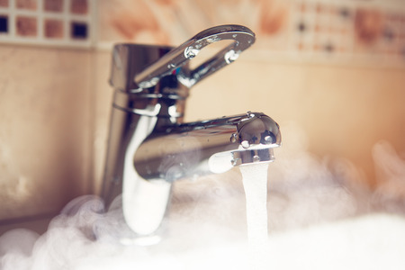 water tap with hot water steamの写真素材
