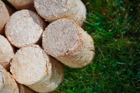 wooden pellets on green grass background