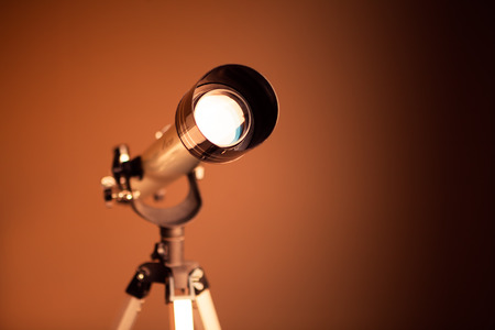 telescope on brown background with copy-spaceの写真素材