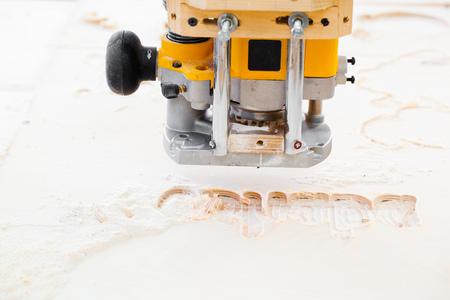 wood milling machine printing some textの写真素材