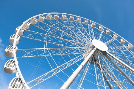white ferris wheel against blue sky backgroundの写真素材