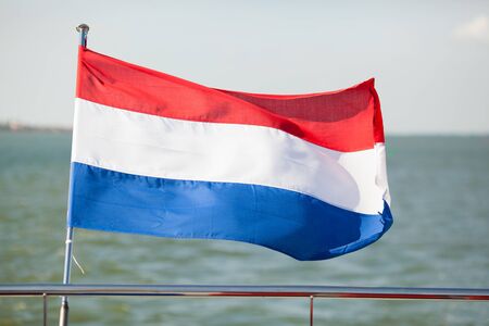 flag of the Netherlands waving on poopの写真素材