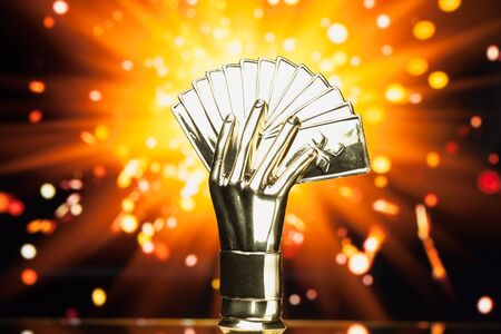 poker cards trophy against shiny sparks backgroundの写真素材