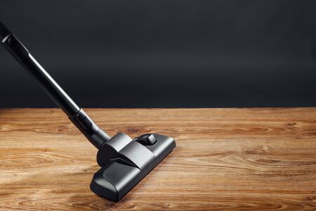 vacuum cleaner brush on wooden floorの写真素材