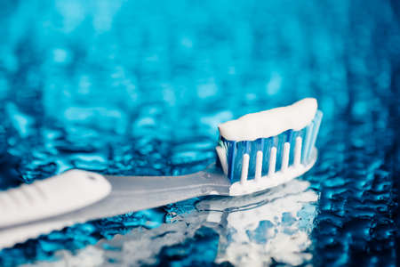 toothbrush on blue background with water dropsの写真素材