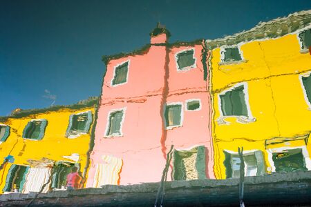 abstract water reflection of colorful houses in Burano, Venice, Italyの写真素材