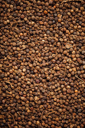 black pepper peppercorns background, closeup view