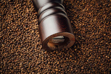 pepper mill on peppercorns backgroundの写真素材