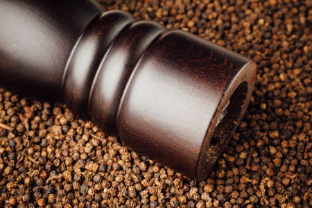 pepper mill on peppercorns backgroundの写真素材