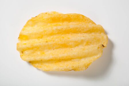 rippled potato chip on white backgroundの写真素材