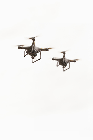 flying drones with camera, quadcopters on white backgroundの写真素材