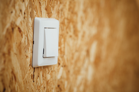 electric light switch, wooden osb background with copy-spaceの写真素材