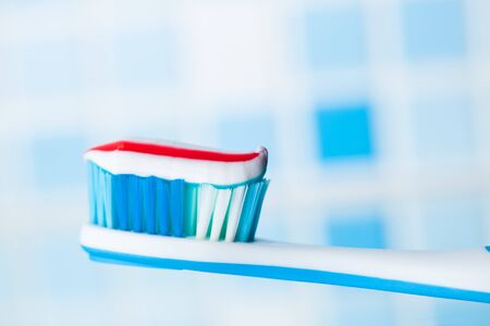 blue toothbrush with red stripe toothpasteの写真素材