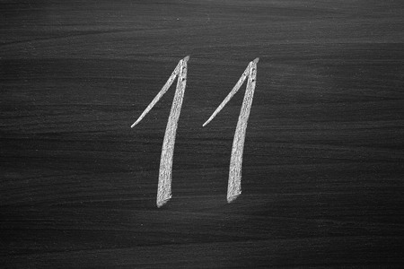 number eleven enumeration written with a chalk on the blackboardの写真素材