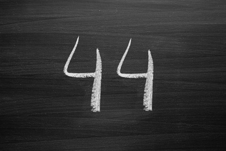 number forty four enumeration written with a chalk on the blackboard