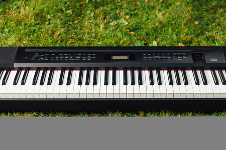 electric piano on green grass backgroundの写真素材