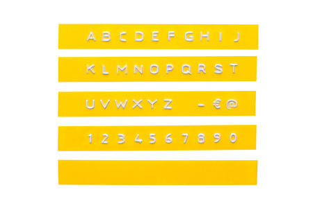 embossed alphabet on yellow plastic tape, isolated on whiteの写真素材