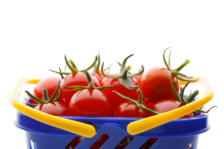 cherry tomatoes in a shopping cart, closeup viewの写真素材