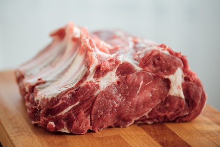 piece of raw beef meat on wooden boardの写真素材