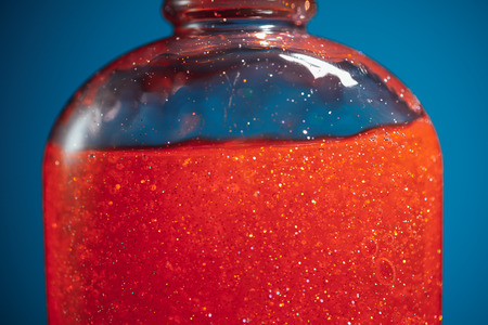 red shower gel on blue background, closeup viewの写真素材