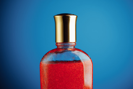 red shower gel on blue background, closeup viewの写真素材