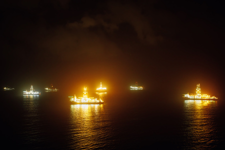 offshore oil drillships at nightの写真素材