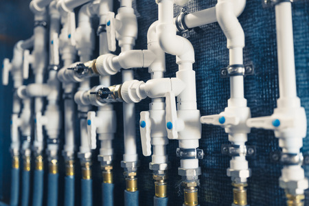 white plastic pipes in boiler room
