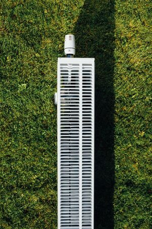 radiator on green lawn, ecological heating conceptの写真素材