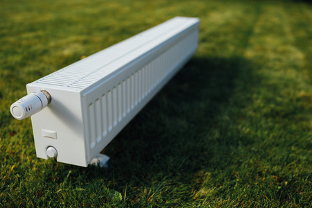 radiator on green lawn, ecological heating conceptの写真素材