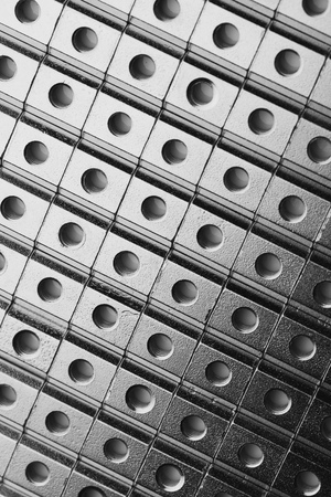Slide screw nuts in a row, abstract industrial backgroundの写真素材
