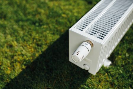 radiator on green lawn, ecological heating conceptの写真素材