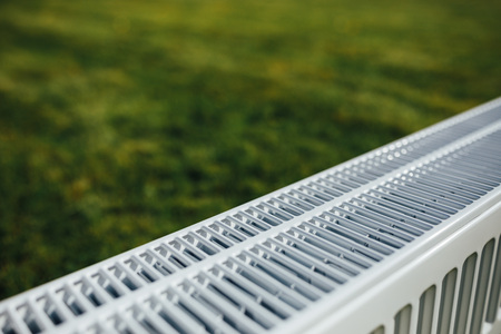 radiator on green lawn, ecological heating conceptの写真素材