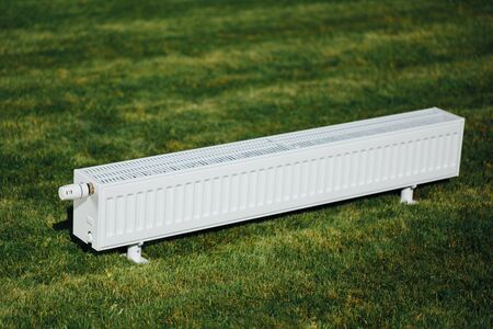 radiator on green lawn, ecological heating conceptの写真素材
