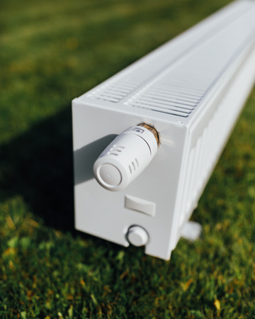 radiator on green lawn, ecological heating conceptの写真素材