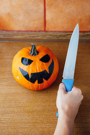preparation of carving jack-o-lantern pumpkin for Halloweenの写真素材