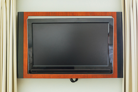 led TV on the wall in wooden frame