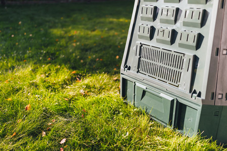 compost bin on green grass backgroundの写真素材