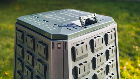compost bin on green grass background