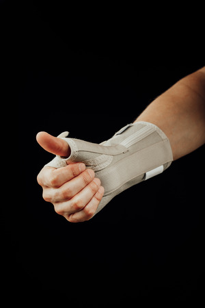 wrist and hand orthotics support for carpal tunnel syndrome healing, isolated on blackの写真素材
