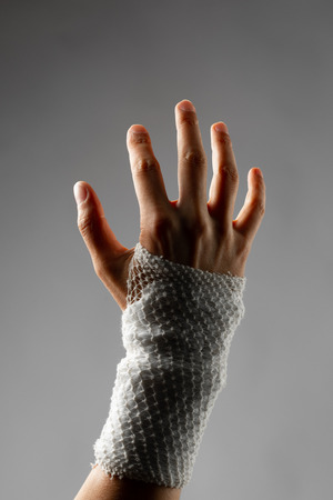 wrist wrapped with healing bandageの写真素材