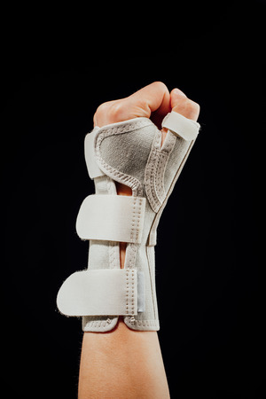 wrist and hand orthotics support for carpal tunnel syndrome healing, isolated on blackの写真素材