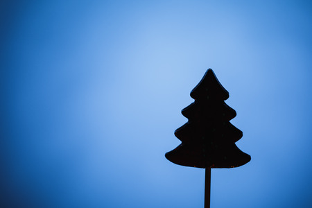 Christmas tree candy silhouette, blue backgroundの写真素材
