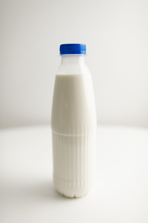 milk bottles on white tableの写真素材