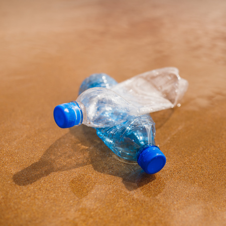 wasted plastic bottles on beach