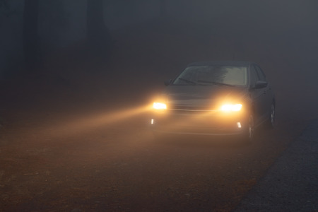 car headlight beams in dense mistの写真素材